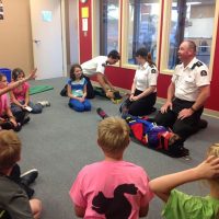 Cadets Alexandra Saumure and Goldie Beckett (playing the casualty) learn first aid strategies from Callum Elsdon-McLeod (far left), main instructor Leanne Wood, and Shawn Beckett.