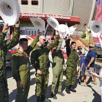 Military members wave their white cowboy hats with Rear-Admiral Art McDonald at the Calgary Stampede. Photo by Ashley Materi, 3rd Canadian Division Public Affairs