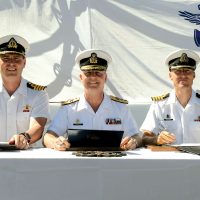 From left to right: Outgoing Commanding Officer, Captain (Navy) Christopher Earl; Commander Maritime Forces Pacific, Rear Admiral Art McDonald; and Incoming Commanding Officer, Captain (Navy) Ed Hooper sign transfer of command certificates. Photo by Cpl Blaine Sewell, MARPAC Imaging Services