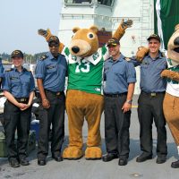 Personnel from HMCS Regina (left to right): Lt(N) Craig Newman, Lt(N) Jessica MacMillan, MS Jamie Boparai, Cdr Colin Matthews, and SLt Dan Presseau gather on the flight deck with Saskatchewan Roughriders’ mascot Gainer the Gopher and ship’s mascot Gunner the Gopher (right). Photos by Peter Mallett, Lookout Newspaper