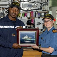 Sub-Lieutenant Lassina Traoré, left, a member of the Ivory Coast Navy, receives a framed photograph of HMCS Summerside from Commanding Officer Lieutenant-Commander Emily Lambert, to remind him of his time as an exchange officer aboard the ship. Photo by OS John Iglesias