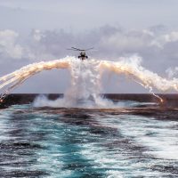 Her Majesty's Canadian Ship REGINA's CH-124 Sea King helicopter deploys flares during a routine flight operation in the Indian Ocean on August 14, 2014. Photo by Cpl Michael Bastien, MARPAC Imaging Services