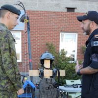 Corporal Ryan Cunningham of Base Logistics speaks with a member of the Naval Tactical Operations Group during the Canada Defence Team Career Networking Fair on Oct. 17. CFB Esquimalt was one of seven military bases across Canada to participate in the first annual career networking fair. Photo by Peter Mallett, Lookout