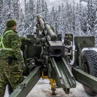 A gunner from the 1st Regiment, Royal Canadian Horse Artillery, prepares for a bore sight inspection of the C3 105mm Howitzer by the Parks Canada Agency. Photo by SLt M.X Dery