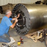 Multi-talented craftsman volunteer, Ben Schwartz, puts the finishing touches to the bouncing bomb replica at the Bomber Command Museum of Canada in Nanton, Alberta. Schwartz also designed and built the mounts for the bomb on the museum’s Lancaster. Photo by John Chalmers