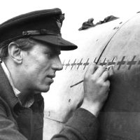 With meticulous care, Beurling chalks up his “kills” on the fuselage of his Spitfire.