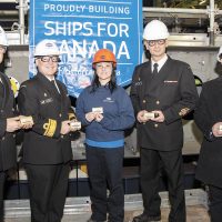 From left: CPO1 Derek Kitching, Atlantic Fleet Chief; RAdm Craig Baines, Commander Maritime Forces Atlantic; Irving Shipbuilding employee Vicki Berg; CPO1 Sylvain Jaquemot, Pacific Fleet Chief, and Rene Belliveau, Irving Shipbuilding VP, Production, at the keel-laying ceremony on Dec. 6, 2018, with a plaque as a memento. Photo by Mona Ghiz, Marlant PA