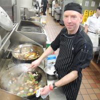 LS Robbie McDougall of Base Foods showcases his special cod fillet meal in the kitchen at Nelles Block. Photo by Peter Mallett, Lookout