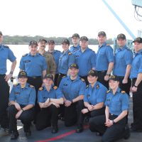 Commodore Topshee and his staff pose as OTTAWA enters Pearl Harbor.