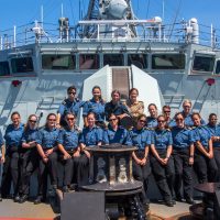 HMCS Regina’s female crew members pose for a photo to celebrate International Women's Day on the Pacific Ocean during Operation PROJECTON on March 10. Photo by Corporal Stuart Evans, Borden Imaging Services