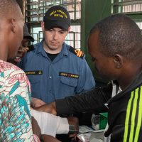Lt(N) Greg Morrow supervises while local teachers practice first aid at Foyer Don Bosco school in Cotonou, Benin, during Operation Projection West Africa. Photo by Cpl Angela Gore