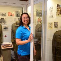 Marina Craig, Vernon Cadet Museum Director of Marketing and Operations, makes a final check on one of the many displays of uniforms before the re-opening of the Vernon Cadet Museum for the summer.
