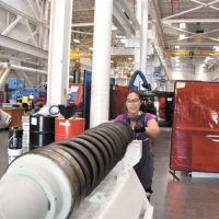 Antoniette Yap, a millwright apprentice at Fleet Maintenance Facility Cape Breton, cleans the 57mm barrel of HMCS Winnipeg’s main gun while conducting an inspection of naval ordnance.