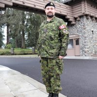 Naval reservist Lieutenant (Navy) Joseph Kinley at the main gate of Joint Base Lewis-McChord after completing Warfighter Exercise 20-3 Feb. 13, just before COVID-19 became a pandemic. Photo Credit Sergeant First Class James Lally