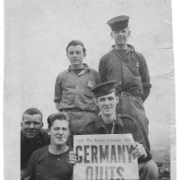 Bill Wilson holds a copy of a local newspaper that reads “Germany Quits”, marking the end of the Second World War.