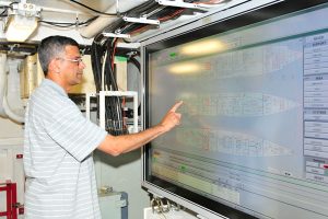 Alkarim Nathoo tests new equipment in HMCS Calgary's Machinery Control Room
