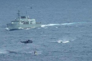 HMCS Ottawa’s boarding party approaches a suspect vessel