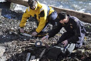 FDU divers wrap the remains of a marine locator marker