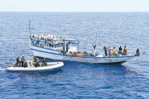 photo by Cpl Rick Ayer, Formation Imaging Services Halifax HMCS Regina naval boarding party approaches fishing dhow.