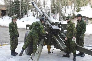 soldiers load the 105mm Howitzer for avalanche control