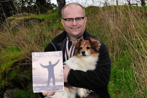 LCol Chris Linford with his book Warrior Rising