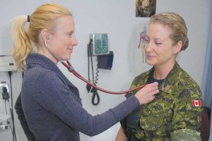 Lt(N) Jodylynn Dans gives Cpl Rhonda Tiekenheinrich a check up