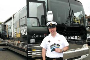 Recruiting bus CPO2 Mike Babcock in front of the recruiting bus