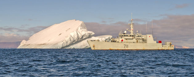 HMCS Summerside sailing past an iceberg