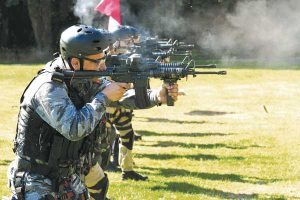 Naval Boarding Party students fire a C8 rifle