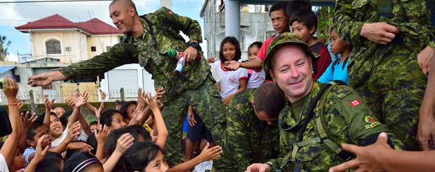 soldiers distribute Izzy dolls