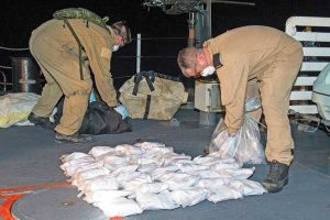crewmembers deal with seized heroin