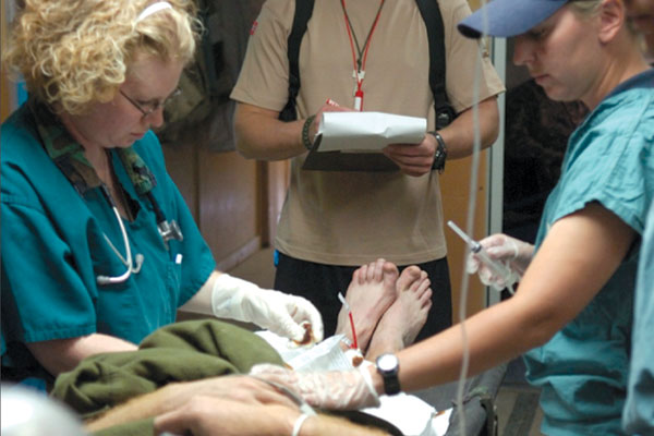 Capt Sandy Robinson works with the medical team on a patient in Afghanistan. Capt Sandy Robinson works with the medical team on a patient in Afghanistan.