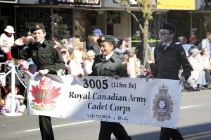 Members of the 3005 (11 Service Battallion) Royal Canadian Army Cadet Corps carry their unit banner past the dais at Centennial Square during the 116th Annual Victoria Day Parade.