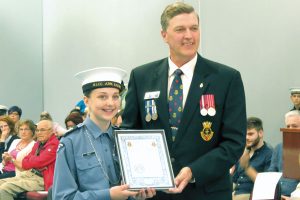 David Yates, National Vice-President of the Navy League Cadets, presents CPO1 Charity Cole with the Medal of Excellence Award at the June 1 Annual Ceremonial Review.