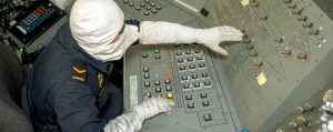OS Morgan Murphy monitors a machinery control console during a firefighting exercise from the mechanical system engineering room of HMCS Regina on May 21, 2014 in support of NATO Reassurance Measures in the Mediterranean Sea.