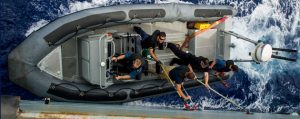 The deck department cleans the port side hull of Her Majesty's Canadian Ship REGINA on May 22, 2014 in support of NATO Reassurance Measures in the Mediterranean Sea.