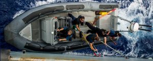 The deck department cleans the port side hull of Her Majesty's Canadian Ship REGINA on May 22, 2014 in support of NATO Reassurance Measures in the Mediterranean Sea.