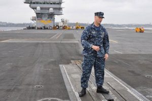 Capt J. J. ‘Yank’ Cummings, Nimitz’s Executive Officer and a former naval aviator, gives an informational tour of flight operations on the carrier’s flight deck. 