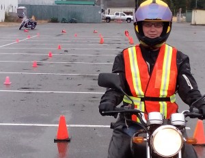 Shelley Fox sits on one of the Learn to Ride 250cc motorbikes at the Jetty parking lot where she was practicing the skills needed to pass the ICBC Motorcycle Skills test.