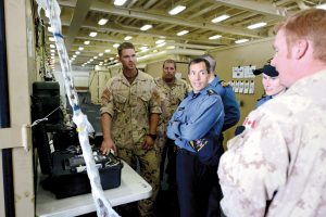 Combined Forces Maritime Component Commander (CFMCC) of Exercise Rim of the Pacific (RIMPAC) 2014 Canadian Rear-Admiral Gilles Couturier, left, speaks with Cdr David Stallworth, commanding officer of Helicopter Mine Countermeasures Squadron (HM) 14, on the bridge of the San Antonio-class amphibious transport dock ship USS Anchorage (LPD 23) while underway off the coast of San Diego. 