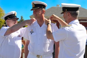 Cpl Blaine Sewell, MARPAC Imaging Services Cmdre Luc Cassivi (centre) receives his new rank from Base Chief Petty Officer CPO1 Shawn Taylor (left) and Commander Maritime Forces Pacific/Joint Task Force Pacific, RAdm Bill Truelove (right). 