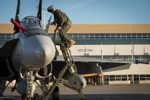 A pilot climbs aboard his CF-188 Hornet aircraft to take off from CFB Bagotville to take part in Operation Impact on Oct. 23.