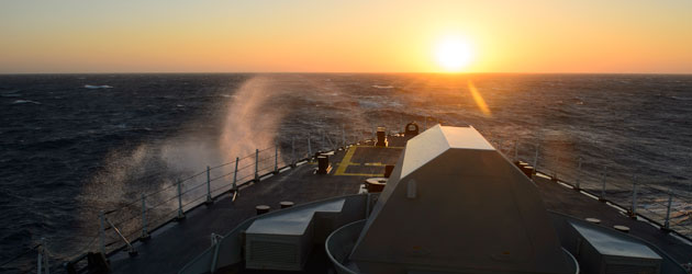 ship sailing into the sunrise