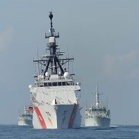US coast guard vessel sails in front of Canadian MCDVs