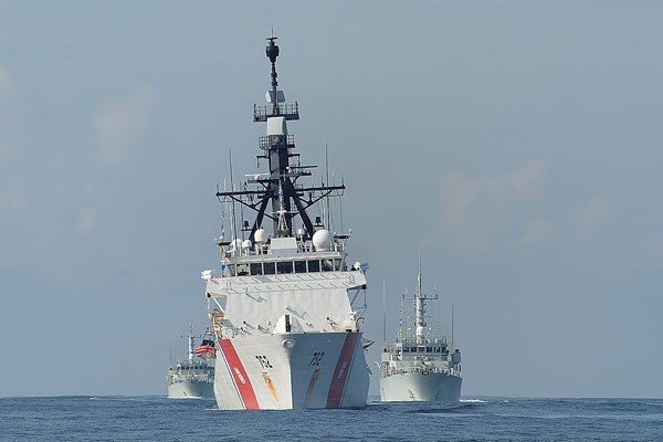 US coast guard vessel sails in front of Canadian MCDVs