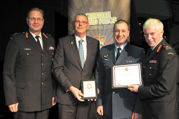 MCpl Michael Bastien was honoured Nov. 25 for his outstanding photography with the Military Photographers Achievement Award, part of the Canadian Armed Forces Photo Contest. Pictured here: BGen Marc Theriault; BMO representative, Rick Campagna; MCpl Bastien; and Vice Chief of the Defence Staff, LGen Guy Thibault, at the Canadian War Museum.