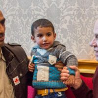 John McCallum with refugees