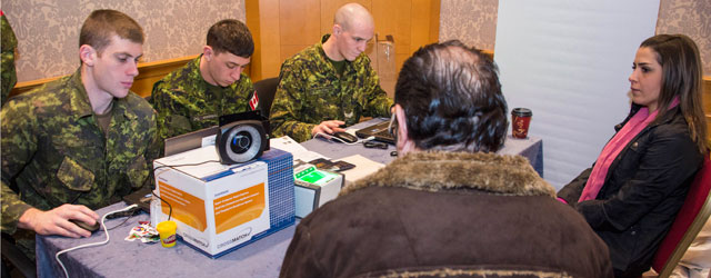 soldiers help refugees apply to Canada