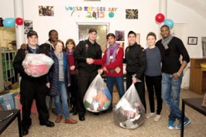 Members of HMCS Winnipeg present clothing donations collected by the ship during its Holiday Clothing Drive to the Joe Nafuma Refugee Centre in Rome, Italy.