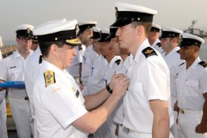 Rear Admiral Gilles Couturier, Commander of Maritime Forces Pacific, presents Master Seaman Brandon McLeod with the NATO Article 5 medal for his contribution to NATO Operation Active Endeavour. 